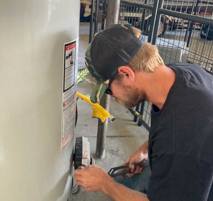 A skilled technician performing water heater repair and maintenance